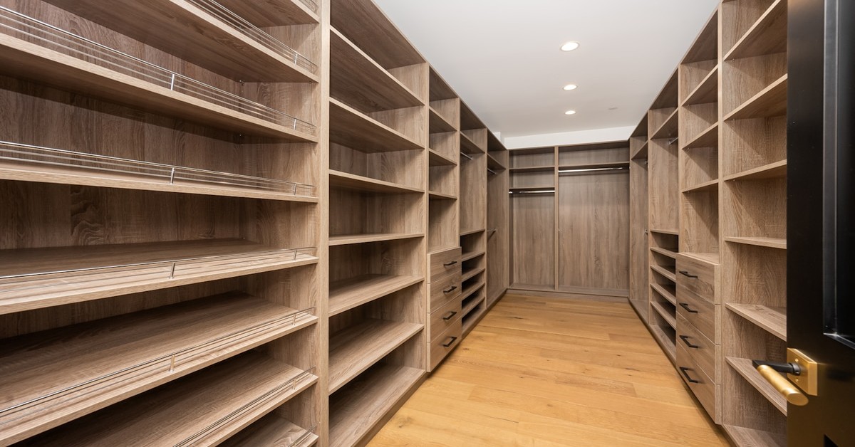 An artisanal walk-in closet with handcrafted wood shelving and natural textures
